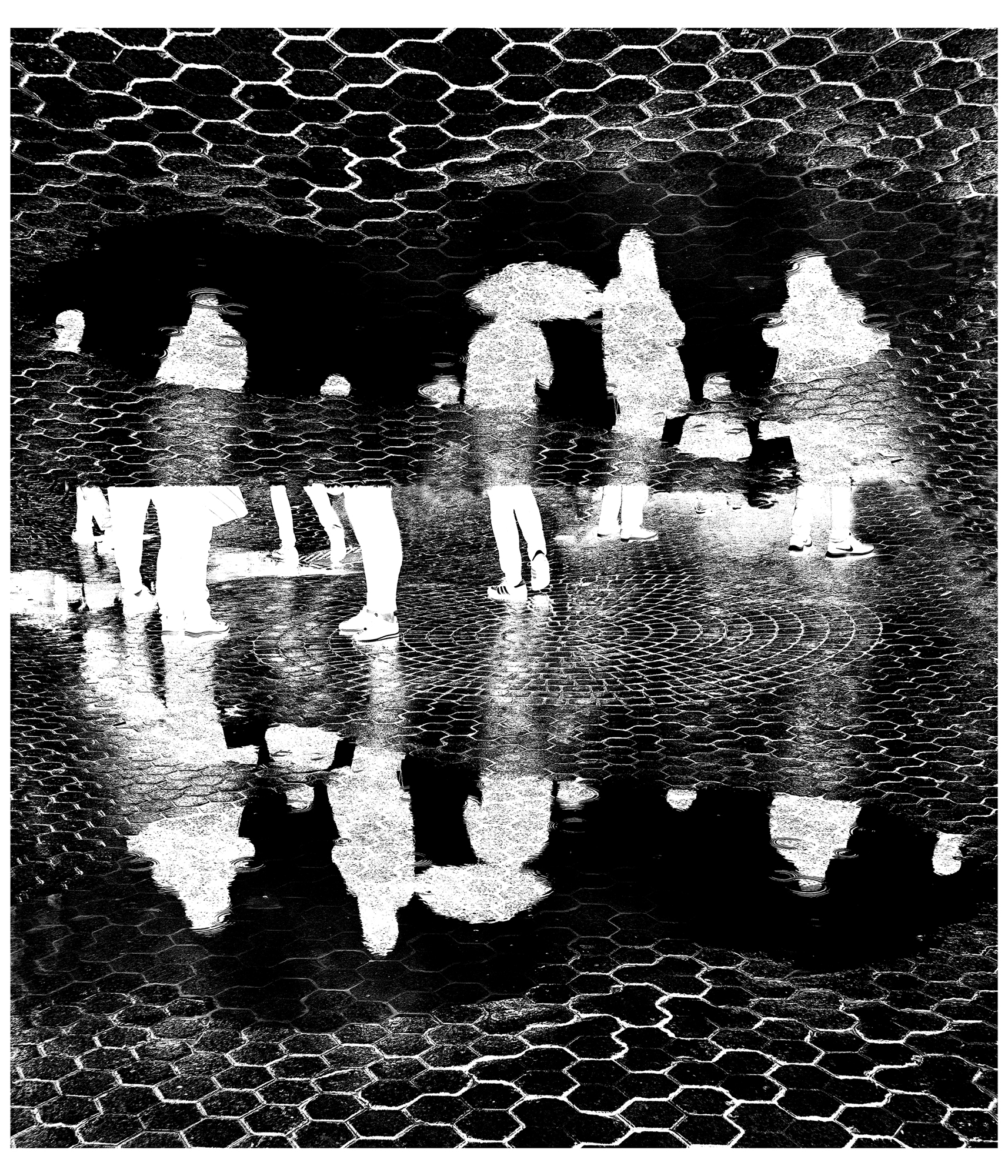 Photograph of people reflected in a puddle of water by Lissette Solórzano Title: Untitled / Sin título; Baryta archival fine art print; 100 x 80 cm; 2023